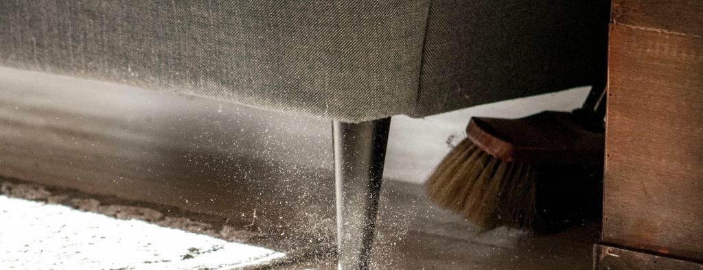 sweeping debris during renovation cleanup