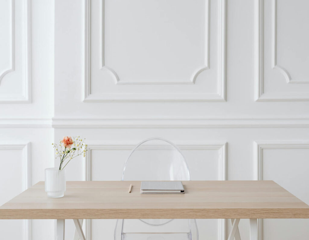 Living Room with white wainscoting, a simple wooden table, and minimalist decor.