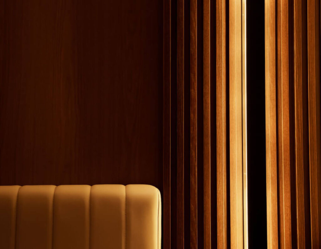 Warm wooden panels with indirect lighting highlighting the texture